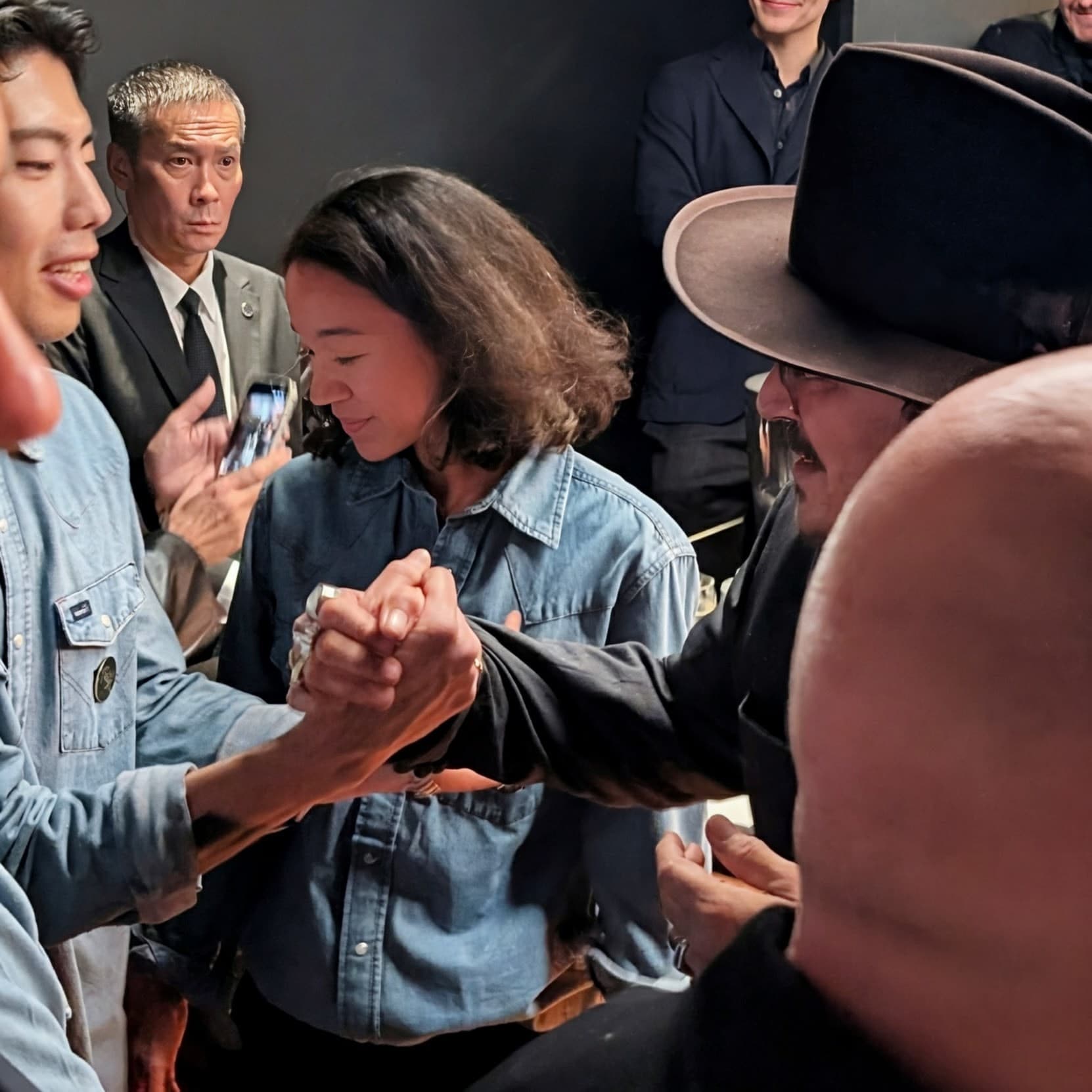 Johnny Depp clasping hands with a team member
