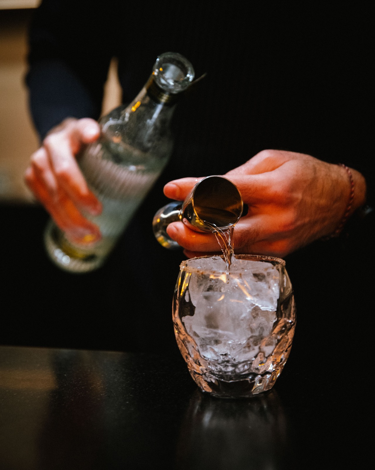 Tequila being poured over ice