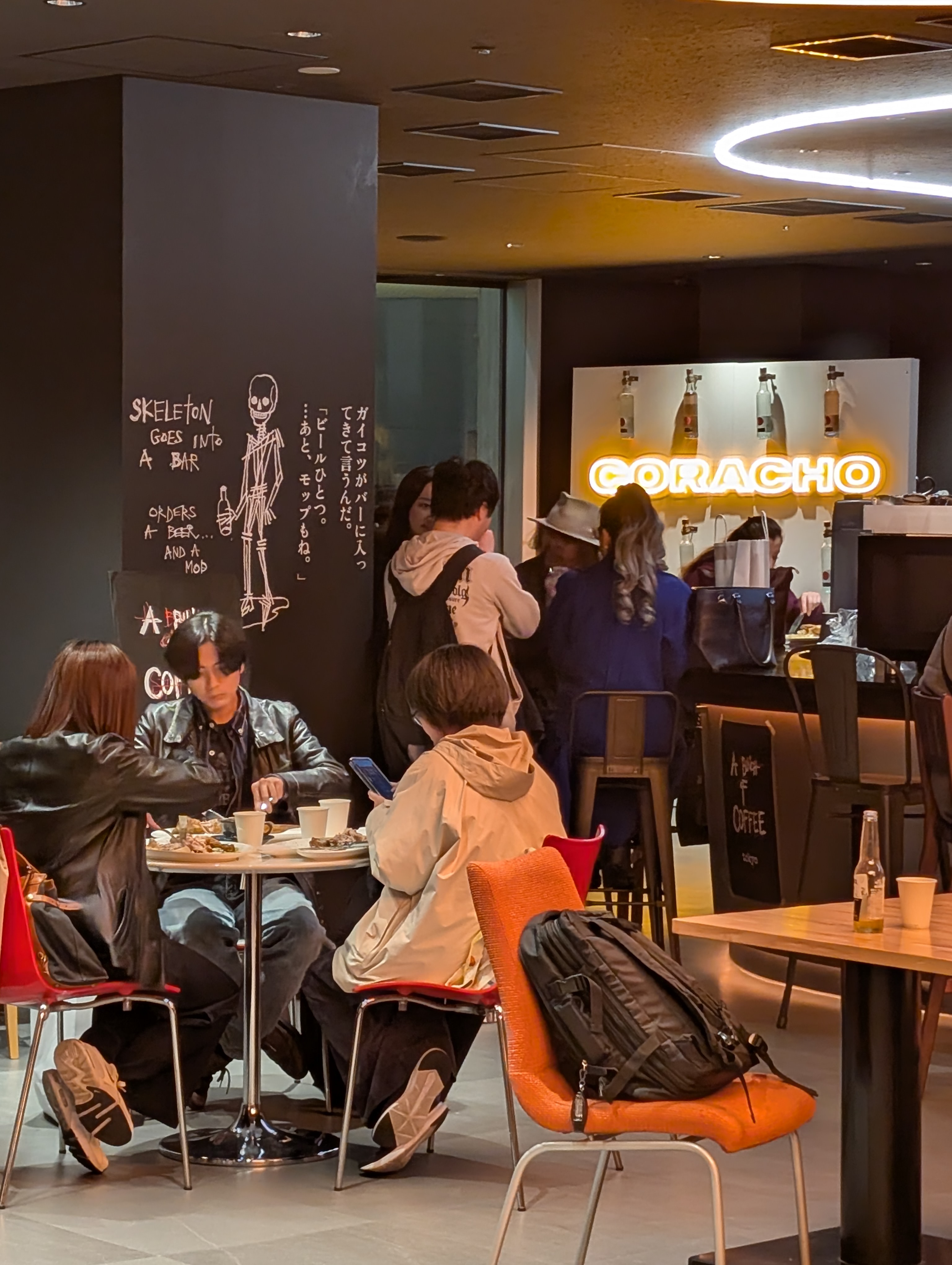 Interior dining space with neon sign at A Bunch of Coffee